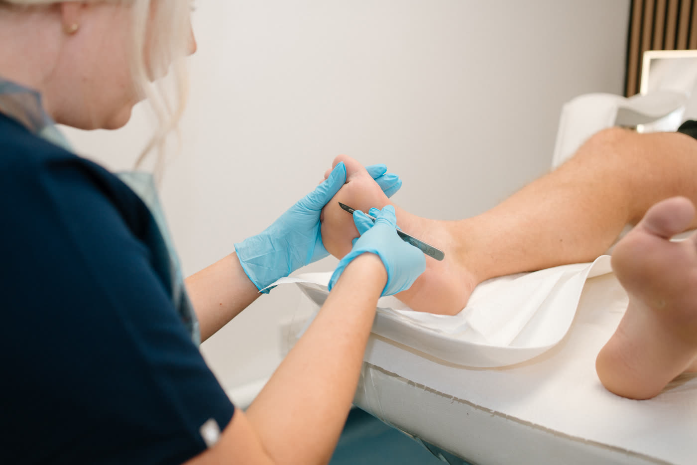 Ashleigh, Foot Health Practitioner, carrying out a foot treatment at The Nightingale Wellness Clinic