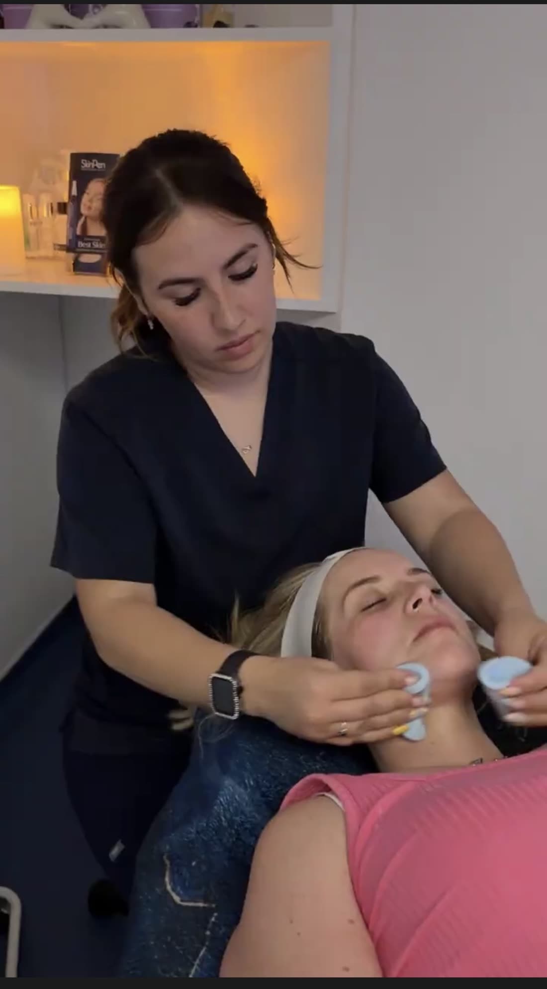 Louise, Skin and Laser Therapist at The Nightingale Wellness Clinic, performing a facial with cooling globes